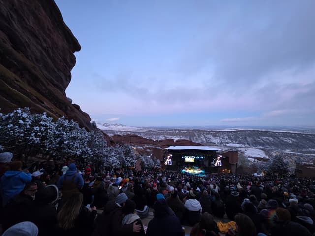 A concert crowd at Red Rocks Amphitheatre at dusk