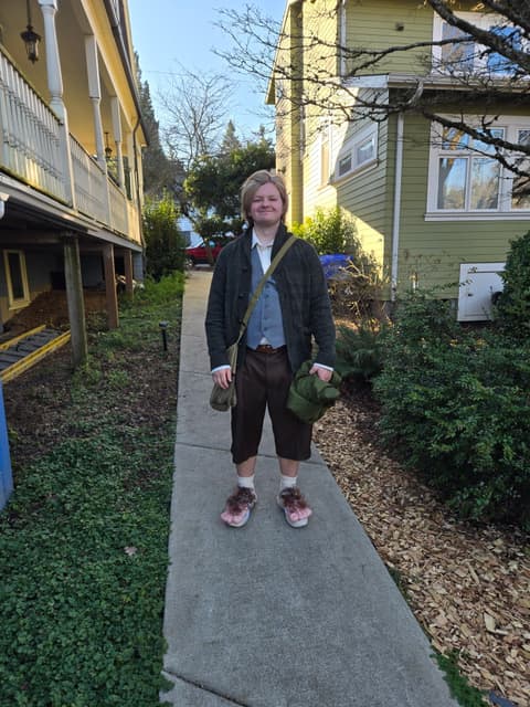 Finn standing on a garden path between houses