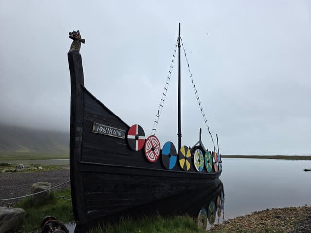 A Viking ship replica with painted round shields
